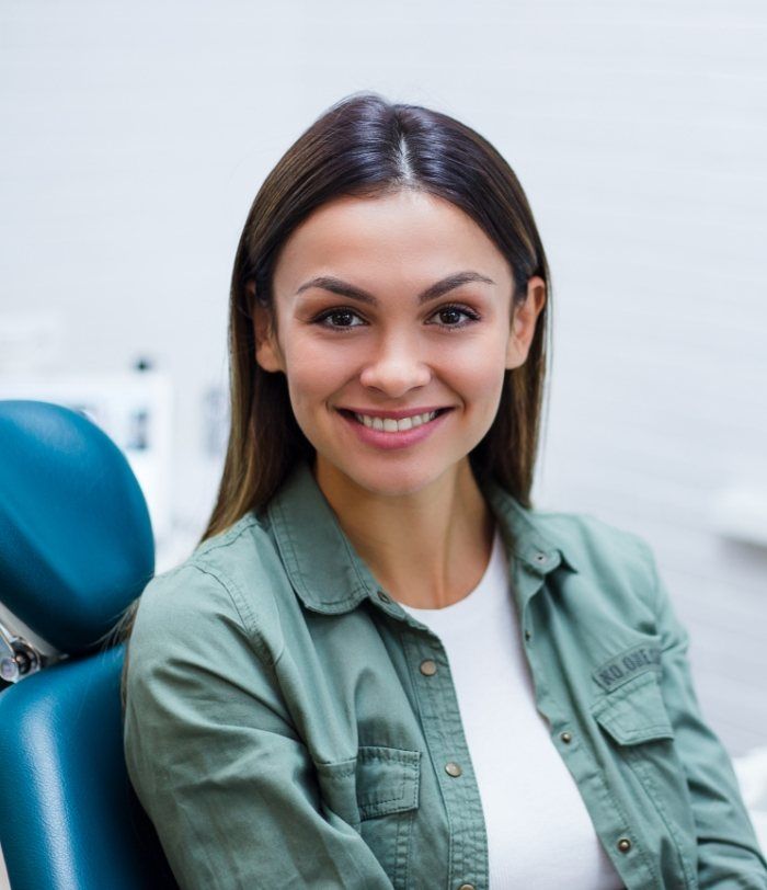 Smiling woman in dental chair at Centennial dental office