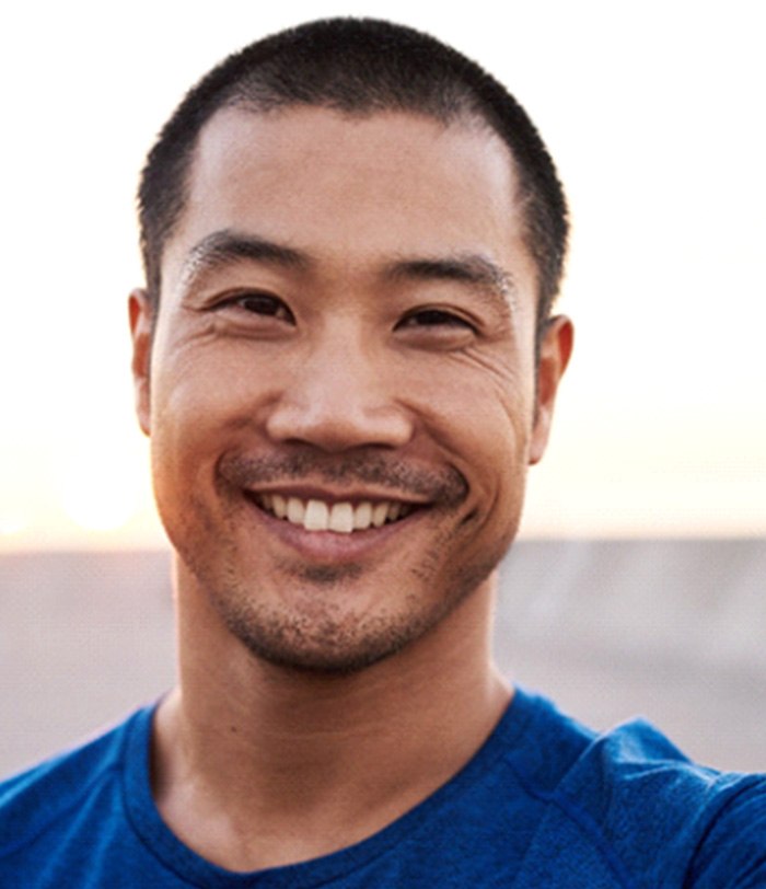 man smiling while standing outside