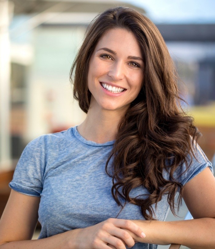 Woman with brown hair smiling after Boto in Centennial