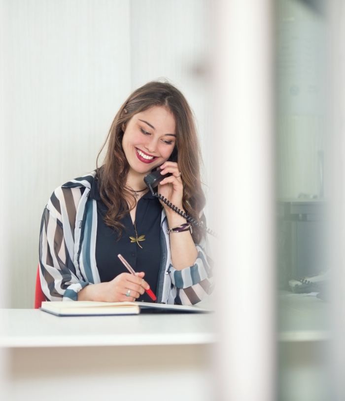 Centennial dental team member smiling while talking on phone