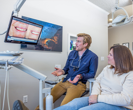 Young woman getting dental veneers from cosmetic dentist