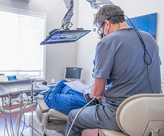 Man getting professional teeth whitening from cosmetic dentist