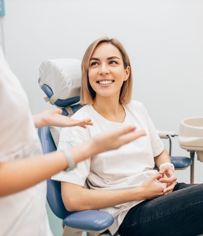 Woman in dental chair smiling at her Centennial dentist