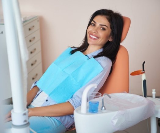Smiling Centennial dental patient sitting in dental chair