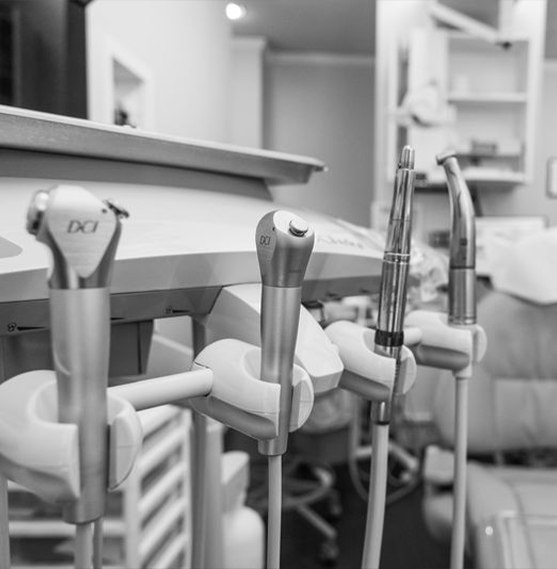 Woman in black shirt smiling in dental chair