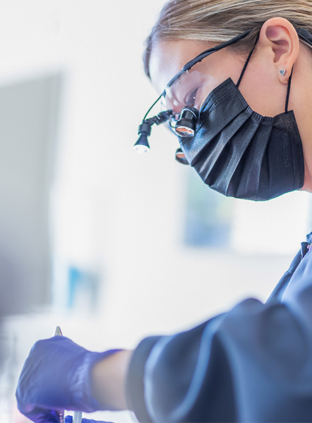 Centennial dental team member cleaning a patient's teeth