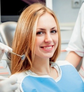 Blonde woman grinning in dental chair
