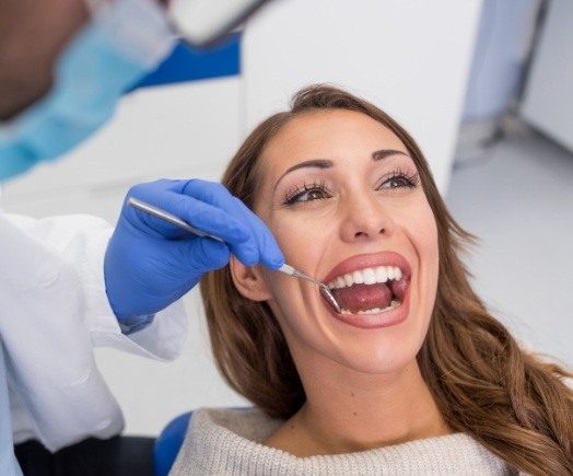 Dental patient opening her mouth for dental checkup