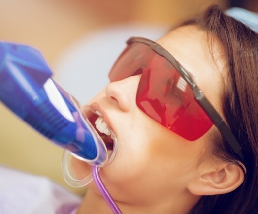 Young girl getting fluoride treatment during preventive dentistry visit