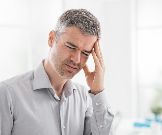 Man holding his temple in pain