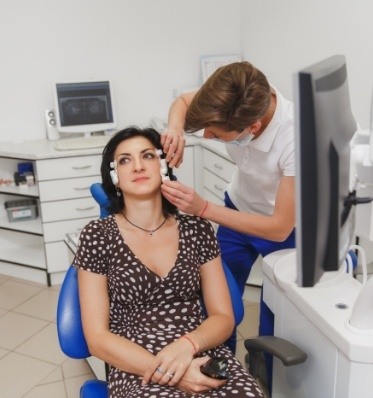 Dentist placing electrodes on a patient's head