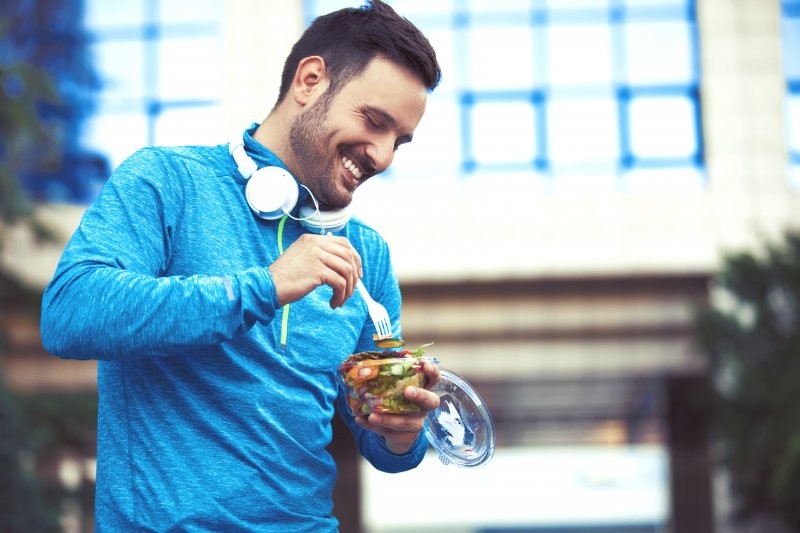 A man smiling and making good lifestyle choices for his dental implants